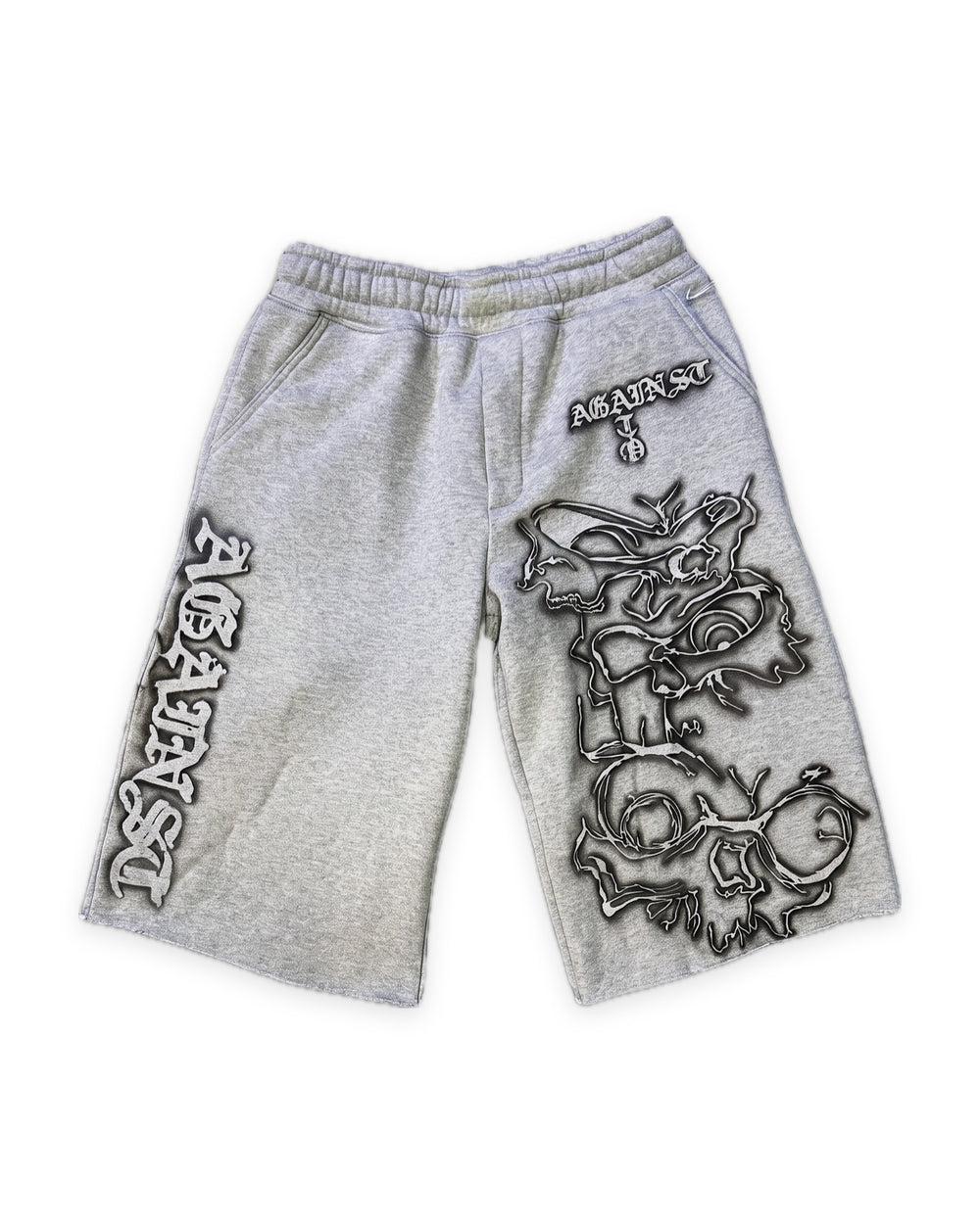 
ATO GREY AIRBRUSH SWEAT JORTS – heather grey sweat jorts with black-outlined airbrushed skull and gothic "Against" lettering, front view