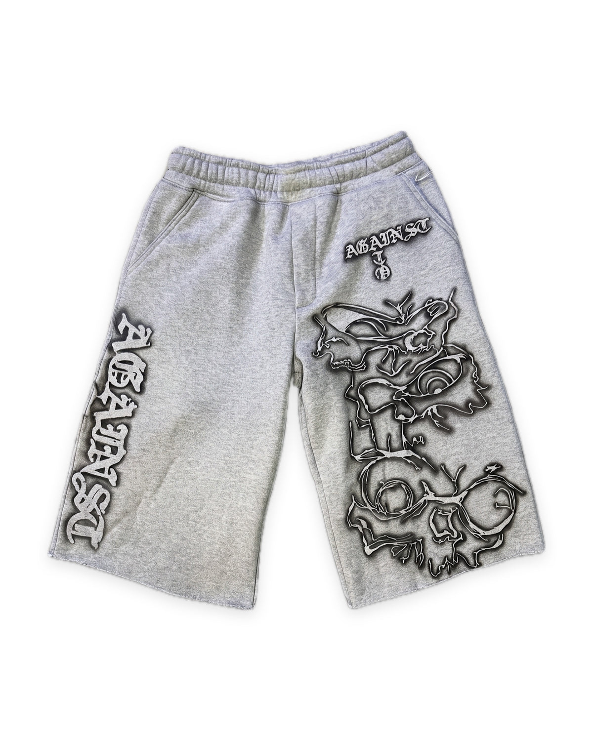 ATO GREY AIRBRUSH SWEAT JORTS – heather grey sweat jorts with black-outlined airbrushed skull and gothic "Against" lettering, front view