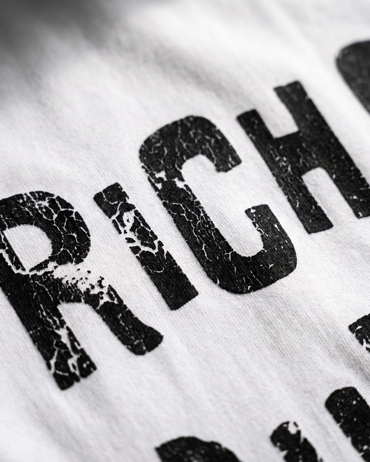 ATO RICH OFF PURPOSE TEE – close-up of the cracked, distressed "Rich Off" lettering