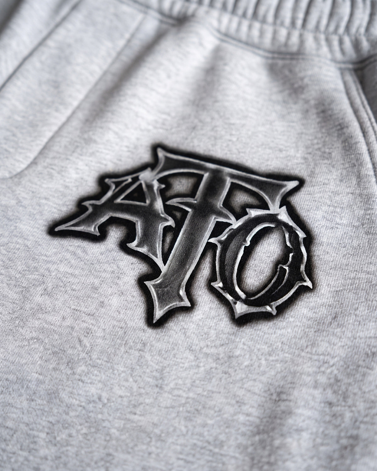 ATO CHROME JORTS – close-up of the chrome gothic ATO logo