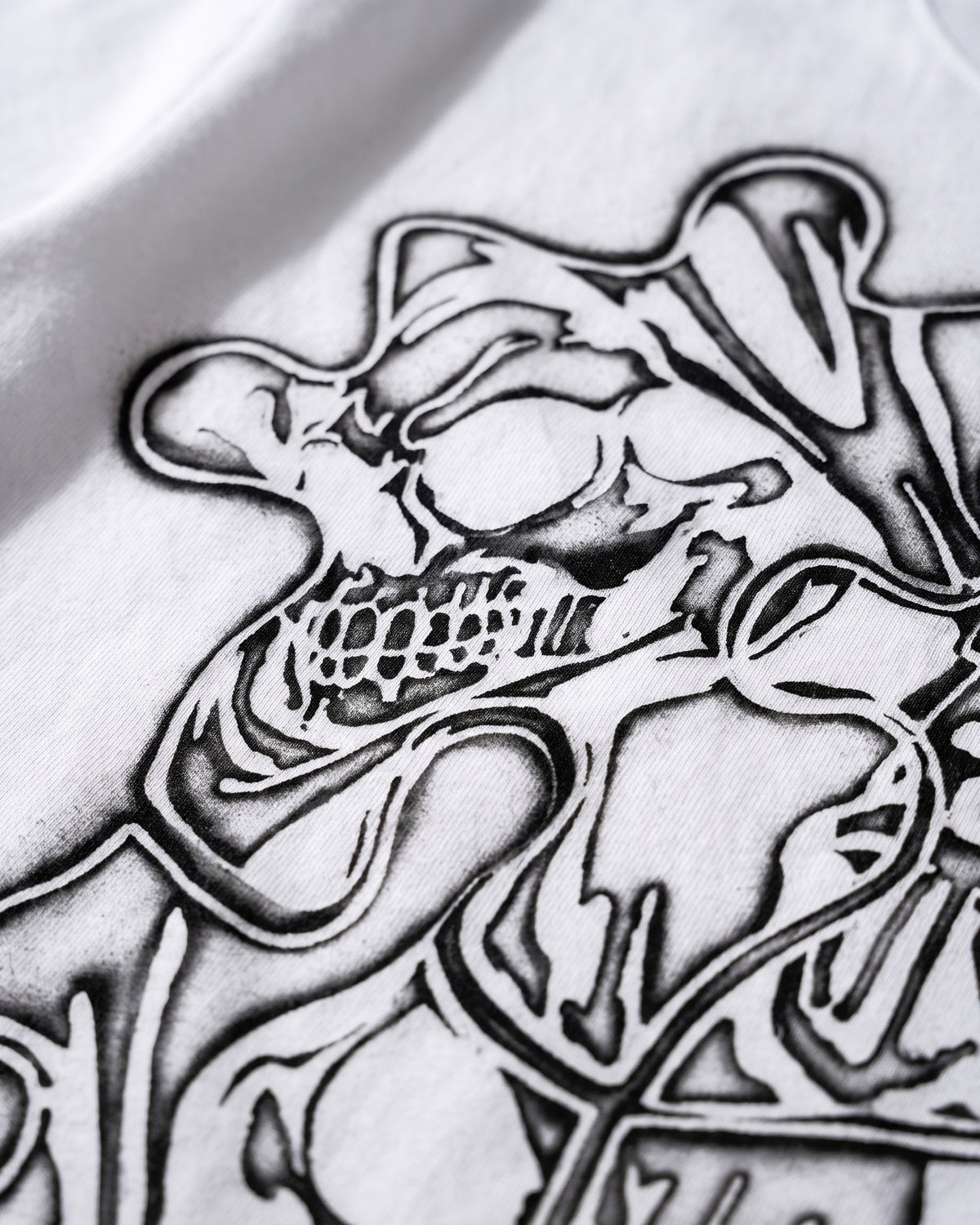 ATO AIR BRUSH TEE – close-up of the airbrushed skull and puzzle linework on the chest