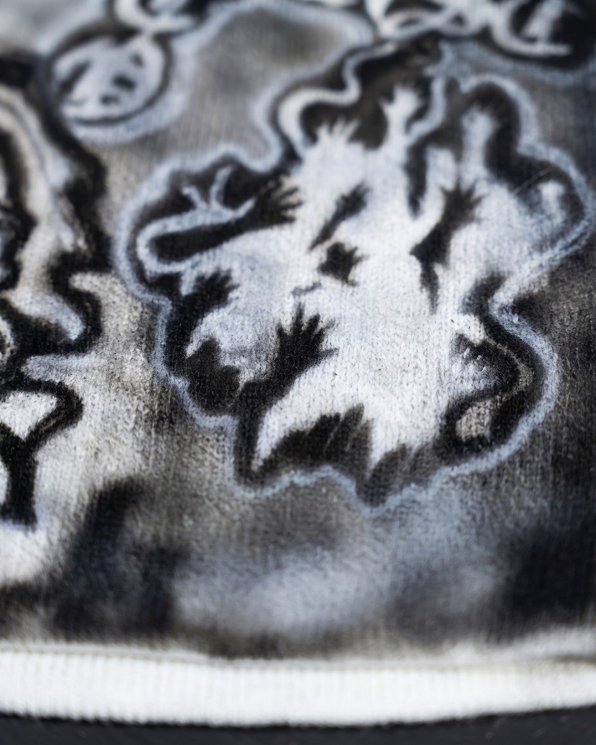 ATO AIRBRUSH White Skelton Beanie – close-up of the airbrushed reaching-hands artwork and white rim