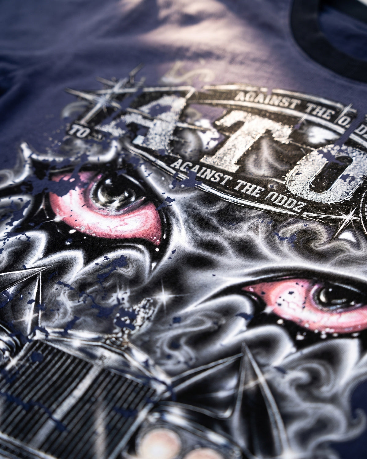 ATO Double RR TEE – close-up of the chrome ATO lettering and pink eyes