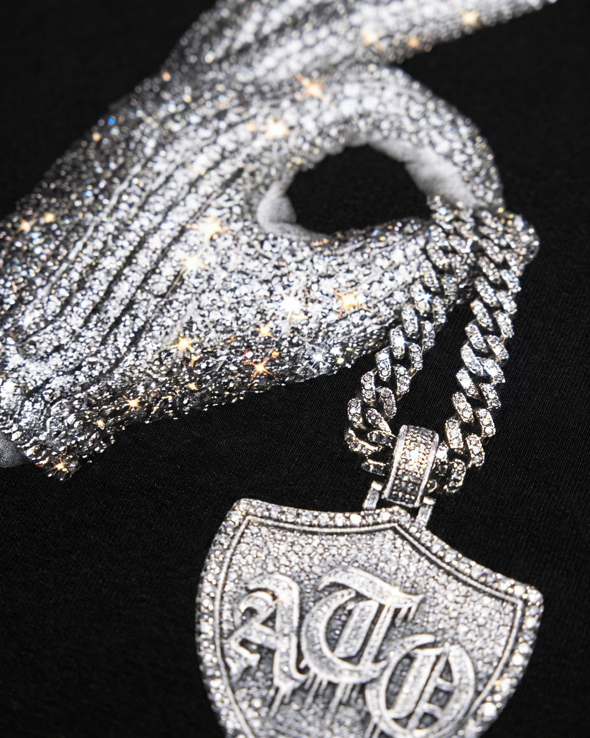 ATO Ice man tee – close-up of the rhinestone glove, chain and ATO shield pendant